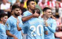 Manchester City midfielder Rodri (C) celebrates his winner at Sheffield United