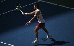 Carlos Alcaraz hits a return to Dan Evans on his way to victory in the US Open third round on Saturday