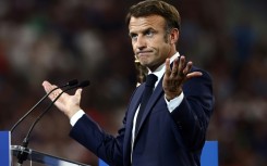 Macron had to pause ahead of giving his speech from a lectern on the pitch ahead of the clash between France and New Zealand