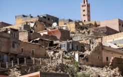 The minaret of a mosque stands behind destroyed houses in Moulay Brahim, Al-Haouz province