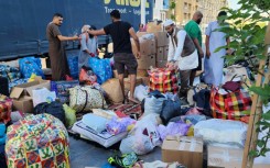 Libyans donate clothes and blankets at a collection point in the capital Tripoli for transport across the nation's political divide to the flood-hit city of Derna