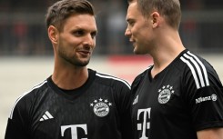 Bayern Munich's goalkeepers Manuel Neuer (R) and Sven Ulreich (L) talk at team training