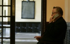 Veteran negotiator: Ahtisaari on the phone in a hotel in Dar es Salaam, Tanzania, in 2005