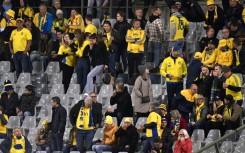 Sweden supporters wait inside the ground after their team's game against Belgium was stopped in the wake of an attack in Brussels