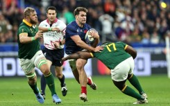 South Africa loose forward Duane Vermeulen (L) pursues France winger Damian Penaud (C) during the Rugby World Cup quarter-final in Paris.
