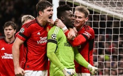 Manchester United's goal-scorer Harry Maguire (L) celebrates with Andre Onana after the goalkeeper's late penalty save against FC Copenhagen