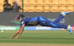 Take flight: Sri Lanka's Maheesh Theekshana dives to field the ball against England on Thursday