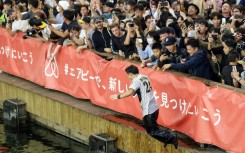 Fans of the Hanshin Tigers threw themselves into Osaka's Dotonbori River after the team won the Japan Series on Sunday