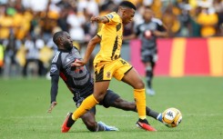 Deon Hotto (L) of Orlando Pirates tackles Mduduzi Shabalala of Kaizer Chiefs during a South African Premiership match in Johannesburg.
