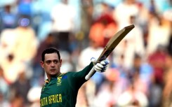 Dangerman: South Africa's Quinton de Kock celebrates after scoring a century against Australia in the group stage win in Lucknow