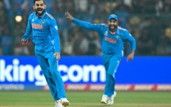 Rare moment: Virat Kohli celebrates with captain Rohit Sharma after taking the wicket of Scott Edwards 