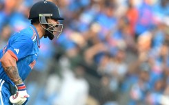 Record-breaker: India's Virat Kohli celebrates after scoring his 50th ODI hundred in a World Cup semi-final against New Zealand in Mumbai