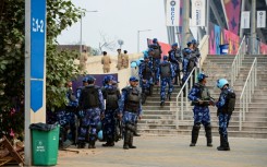 Security personnel gather outside the Narendra Modi Stadium in Ahmedabad on November 18