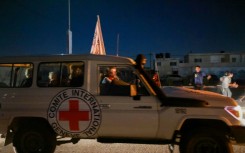 An International Red Cross vehicle reportedly carrying hostages released by Hamas crosses the Rafah border point in the Gaza Strip