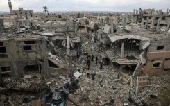 Palestinians inspect the destruction caused by Israeli strikes on their homes in the village of Khuzaa, near Abasan in the southern Gaza Strip