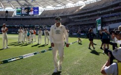 Australia's players applaud teammate Nathan Lyon (C) after he took his 500th Test wicket