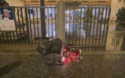 People light candles for victims of Prague shooting at makeshift memorial 