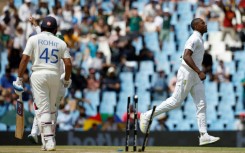 Kagiso Rabada (R) celebrates after bowling Indian batsman Rohit Sharma (L) in Centurion