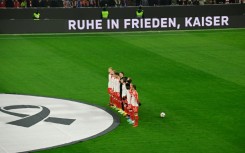 Bayern Munich's players observe a moment of silence in honour of late German football legend Franz Beckenbauer before their home clash with Hoffenheim on Friday