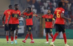 Mabululu, Angola's number 19, celebrates scoring his team's equaliser against Algeria from the penalty spot