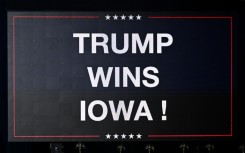 A sign announcing the Iowa win of US President and Republican presidential hopeful Donald Trump is displayed at a watch party during the 2024 Iowa Republican presidential caucuses in Des Moines