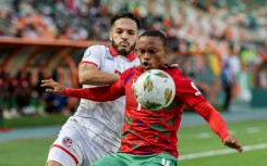 Wajdi Kechrida (L) of Tunisia and Riaan Hanamub of Namibia fight for possession.
