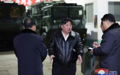 North Korean leader Kim Jong Un (C) has toured numerous weapons manufacturing facilities in recent months