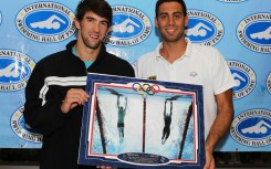 US swim star Michael Phelps, left, and Milorad Cavic hold a famous Sports Illustrated photo of their 100m butterfly photo finish, in which Phelps won gold at the 2008 Olympics, a sign of the iconic nature of the magazine which had its staff fired