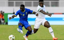 Simon Msuva (L) of Tanzania shields the ball from Lameck Banda of Zambia.
