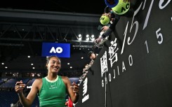 China's Zheng Qinwen signs autographs for fans after her victory against France's Oceane Dodin