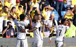 Real Madrid's French midfielder Aurelien Tchouameni (L) celebrates scoring the winner against Las Palmas to take his team top of La Liga