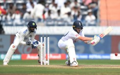 Ollie Pope lines up a reverse sweep as India's wicketkeeper Srikar Bharat watches 