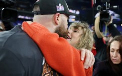 Kansas City tight end Travis Kelce shares a kiss with girlfriend Taylor Swift after the Chiefs booked a return to the Super Bowl with a victory over the Baltimore Ravens