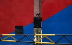 A policeman peeps through the main gate of the Adiala jail during the hearing of jailed former prime minister Imran Khan