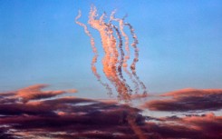 Smoke plumes trail from a salvo of rockets fired towards Israel, pictured from the southern Gaza Strip