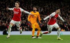 Arsenal's Gabriel Martinelli  (R) celebrates scoring after a mistake from Liverpool keeper Alisson Becker