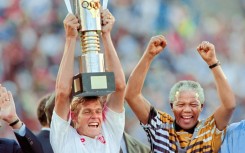 South Africa captain Neil Tovey lifts the Africa Cup of Nations trophy in 1996 as then President Nelson Mandela celebrates.  
