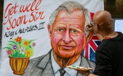 An artist finishes off a painting wishing Britain's King Charles III a speedy recovery