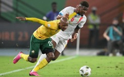 South Africa defender Khuliso Mudau (L) fights for the ball with DR Congo midfielder Aaron Tshibola