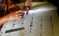 A woman marks a ballot paper with a fingerprint in Karachi during national and provincial elections in Pakistan last week