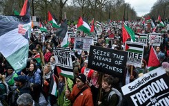 Pro-Palestinian activists and supporters wave flags and carry placards during a National March for Palestine in central London 