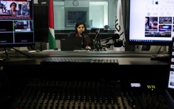 Palestinian radio presenter Maysam Barghouti, 36, sits in the studio at Radio Ajyal