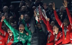 Liverpool manager Jurgen Klopp (C) and Virgil van Dijk lift the League Cup