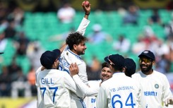 India's Kuldeep Yadav (2L) celebrates after taking five-wicket haul during the first day of the fifth Test