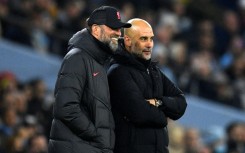 Liverpool manager Jurgen Klopp (L) and Manchester City boss Pep Guardiola