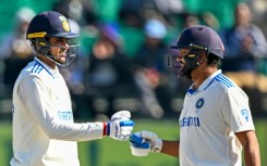 India's captain Rohit Sharma (R) fist bumps Shubman Gill during the second day of the fifth Test against England 