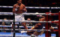 Down and almost out:  Anthony Joshua sends Francis Ngannou to the canvas