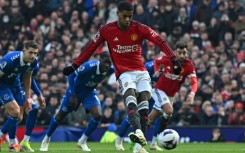 Spot on: Marcus Rashford (centre) scored Manchester United's second goal against Everton