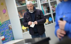 A voter waits to cast his ballot at a polling station in Espinho near Porto in northern Portugal