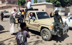 Fighters of a militia raised by Sudan's regular army patrol the streets of Gedaref